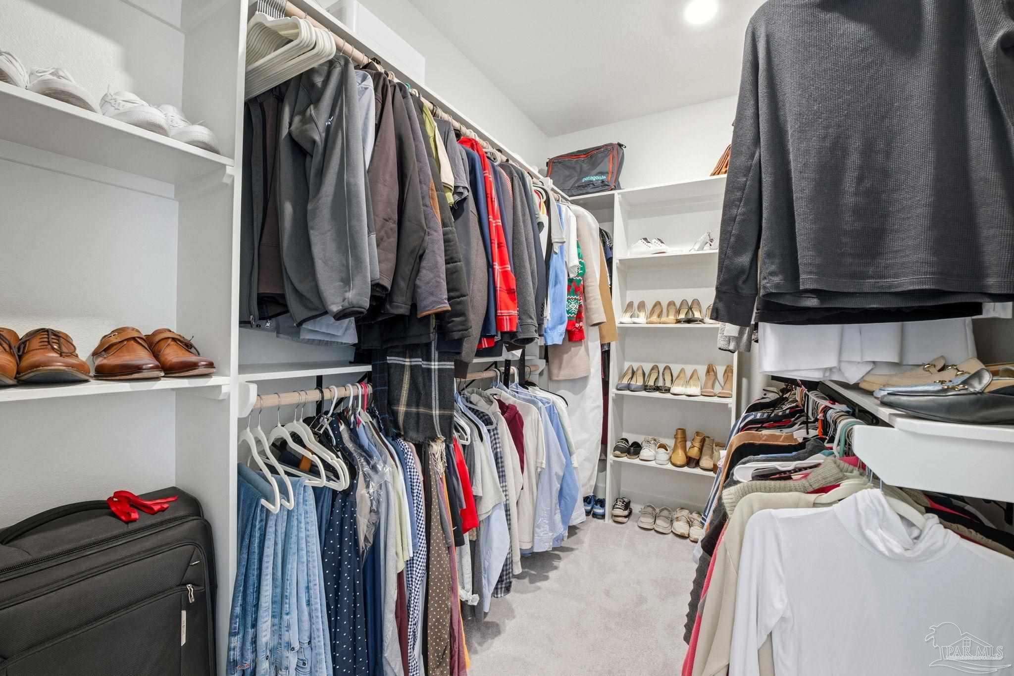 6228 Dry Crk Road Molino, FL 32577 - Photo 27 of 64 a view of walk in closet with clothes and shoes