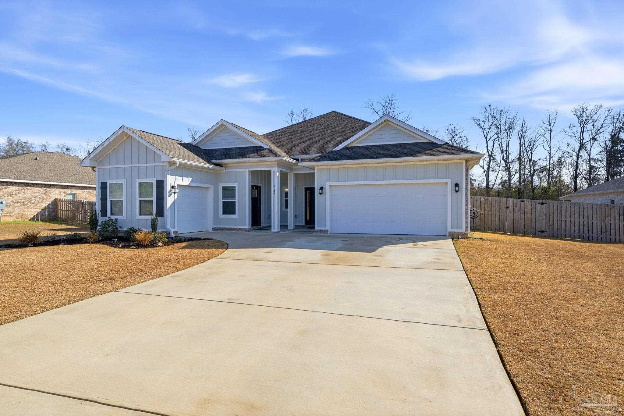 6228 Dry Crk Road Molino, FL 32577 - Photo 3 of 64 a front view of a house with a yard and garage
