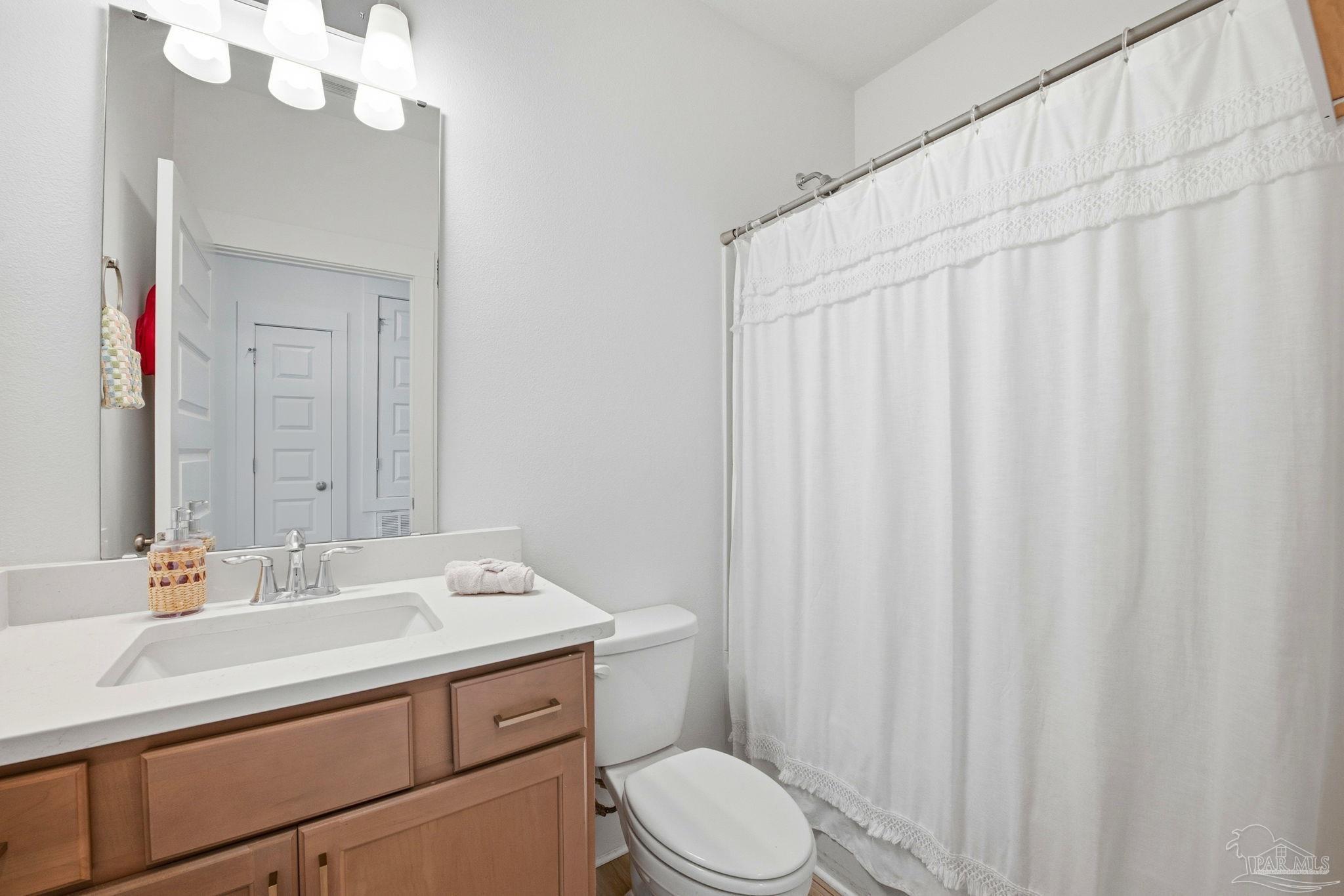 6228 Dry Crk Road Molino, FL 32577 - Photo 35 of 64 a bathroom with a sink a toilet and a mirror