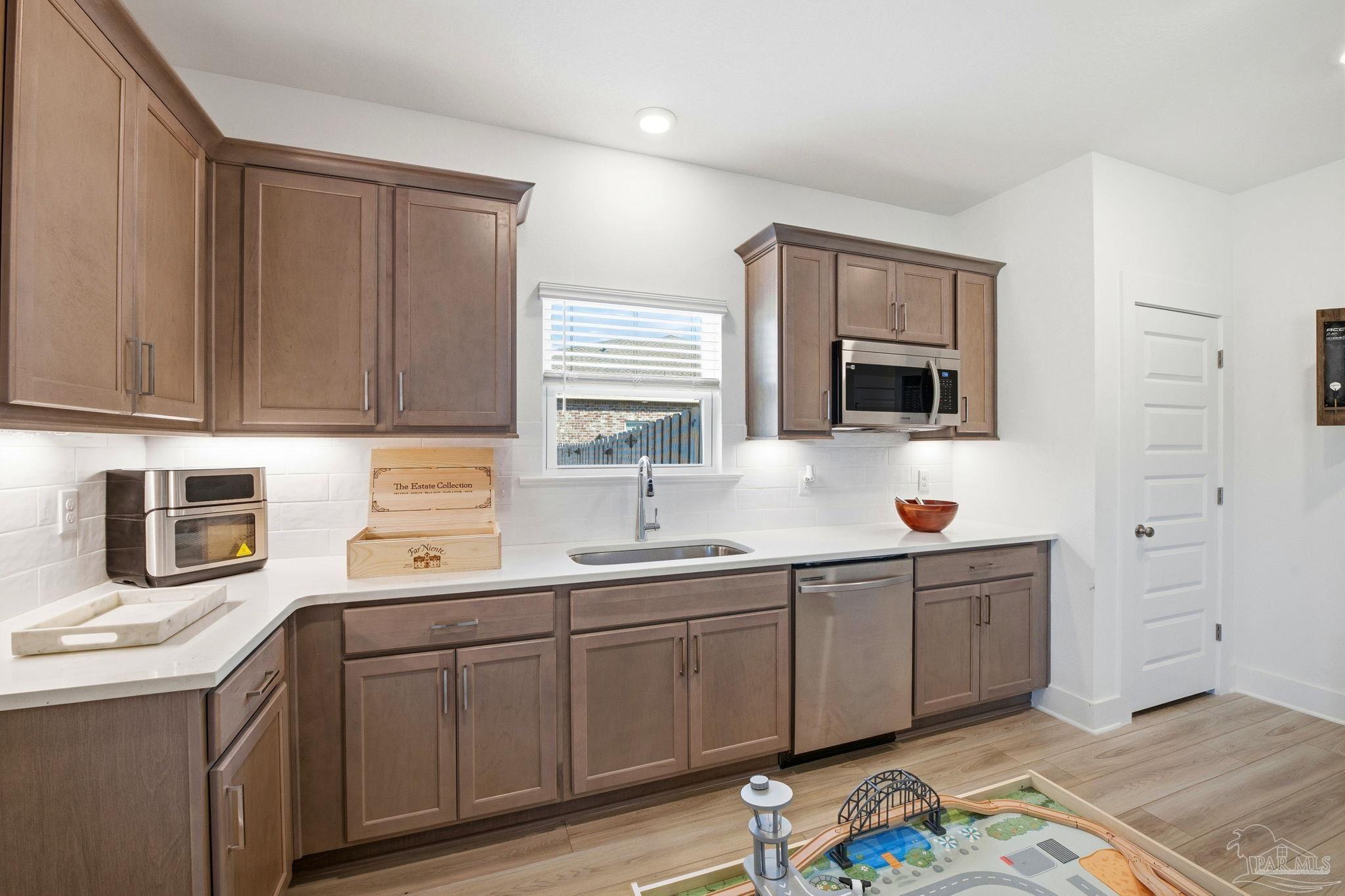 6228 Dry Crk Road Molino, FL 32577 - Photo 42 of 64 a kitchen with a sink cabinets and stainless steel appliances
