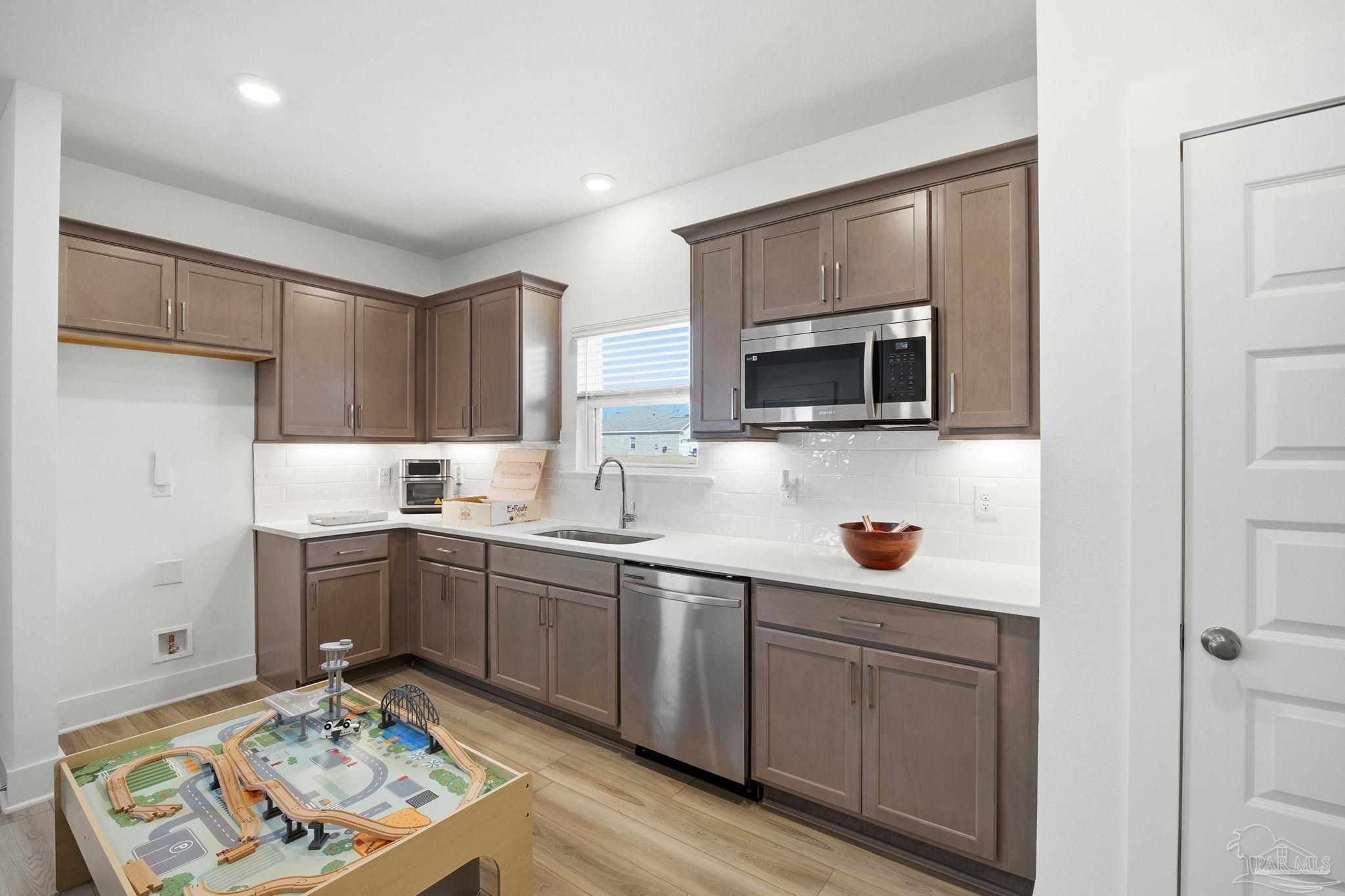 6228 Dry Crk Road Molino, FL 32577 - Photo 43 of 64 a kitchen with cabinets a sink and stainless steel appliances