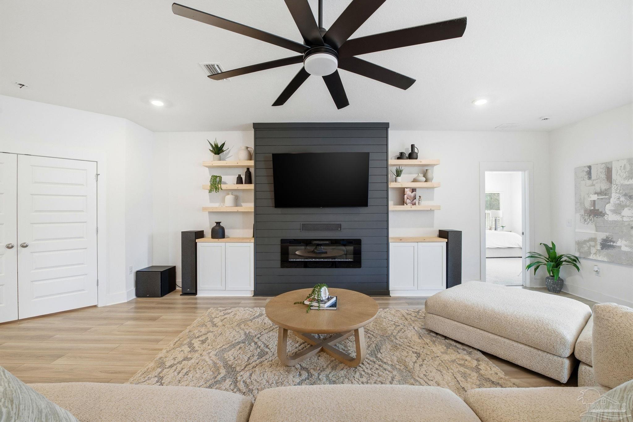 6228 Dry Crk Road Molino, FL 32577 - Photo 9 of 64 a living room with furniture a fireplace and a flat screen tv