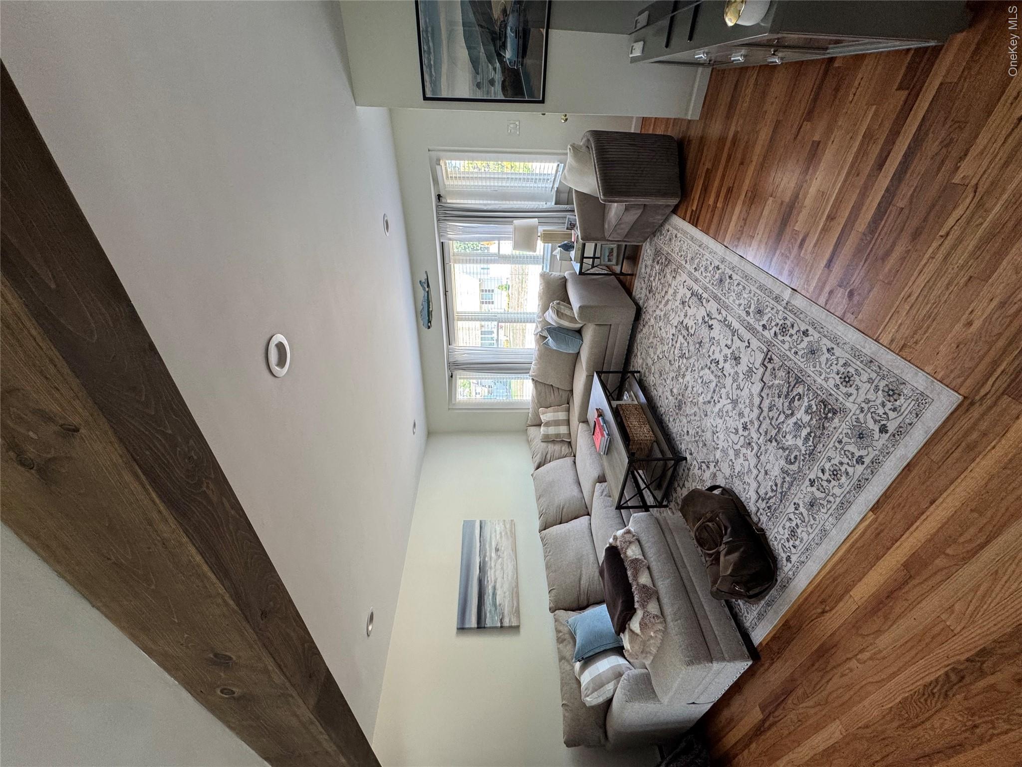338 Carnation Road West Islip, NY 11795 - Photo 4 of 18 Living area featuring exposed wood ceiling beams and recessed lighting
