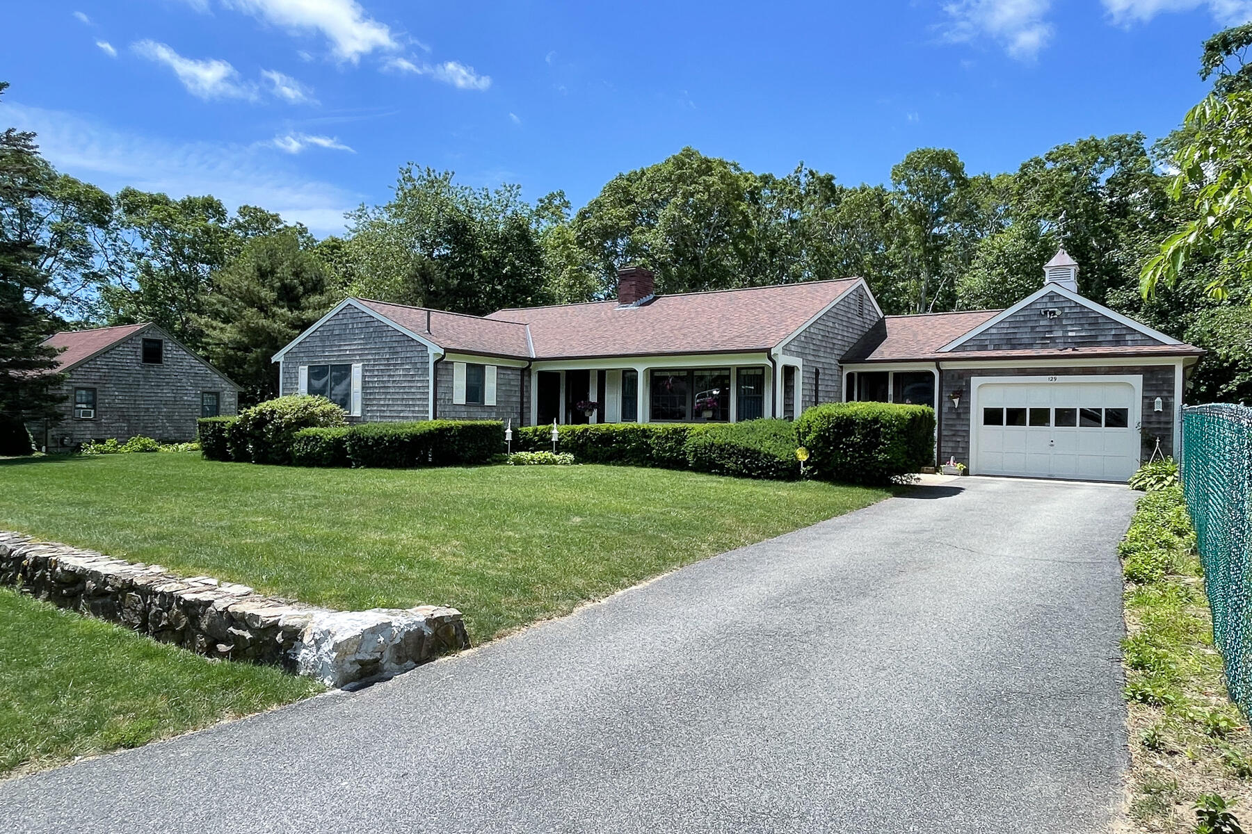 129 Bacon Road Hyannis, MA 02601 - Photo 1 of 43 a front view of a house with a yard