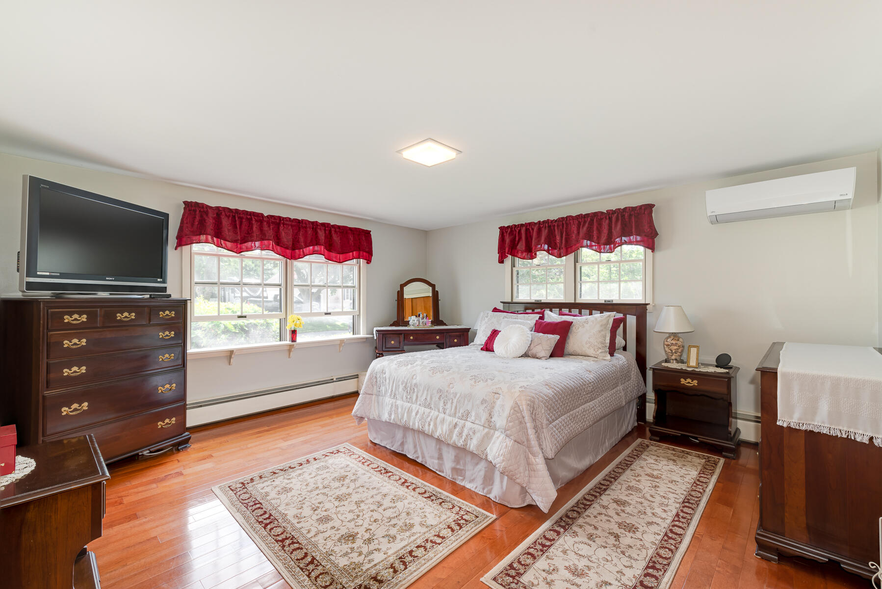 129 Bacon Road Hyannis, MA 02601 - Photo 20 of 43 a bedroom with a bed and a flat screen tv