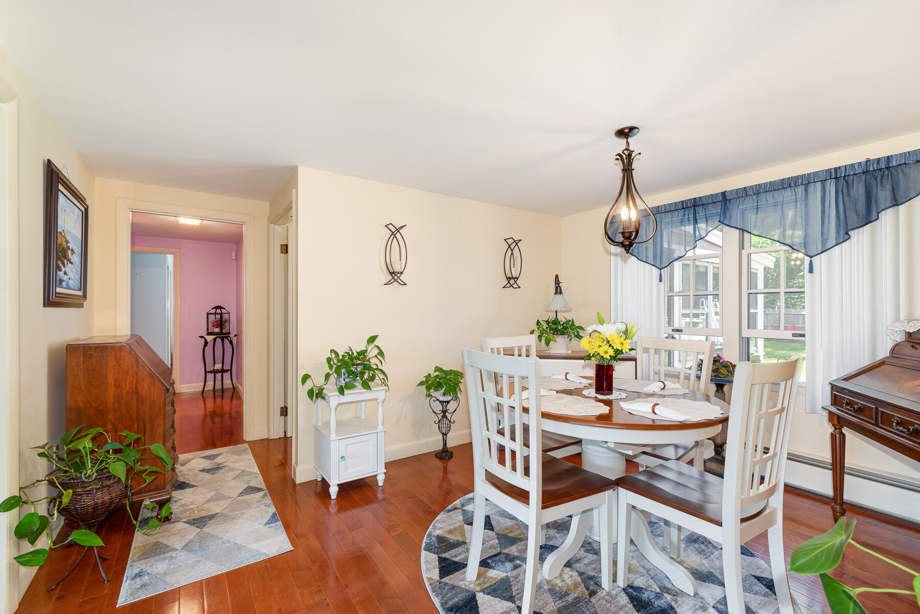 129 Bacon Road Hyannis, MA 02601 - Photo 8 of 43 a dining room with furniture one side kitchen view and wooden floor