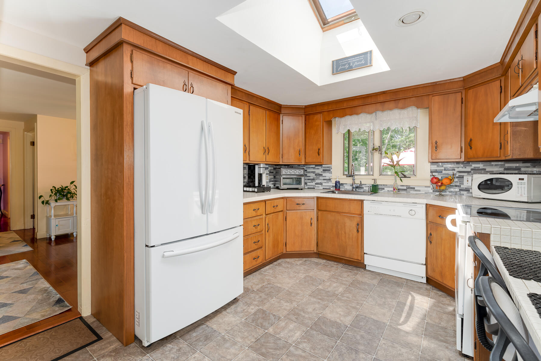 129 Bacon Road Hyannis, MA 02601 - Photo 9 of 43 a kitchen with a refrigerator a stove top oven a sink and a window