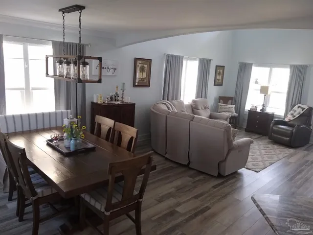 a view of a dining room with furniture window and wooden floor