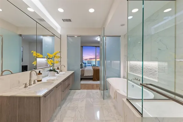a bathroom with a tub sink and mirror