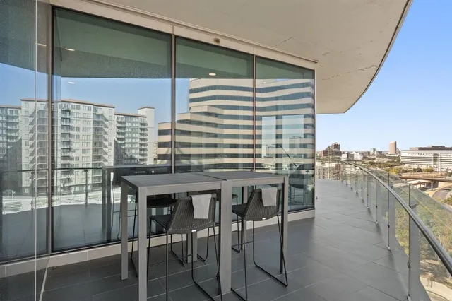 a balcony with a table and chairs