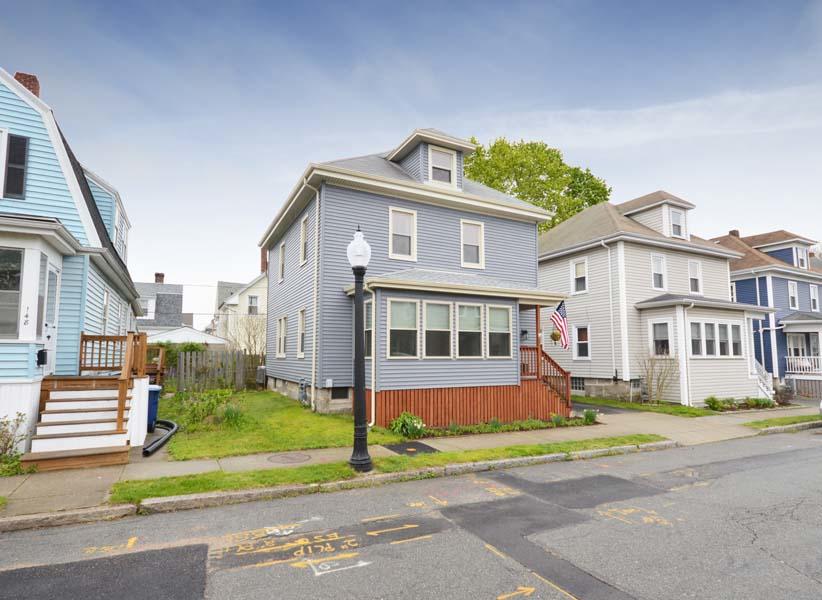 156 Rounds Street New Bedford, MA 02740 - Photo 3 of 24 a front view of a house with a yard