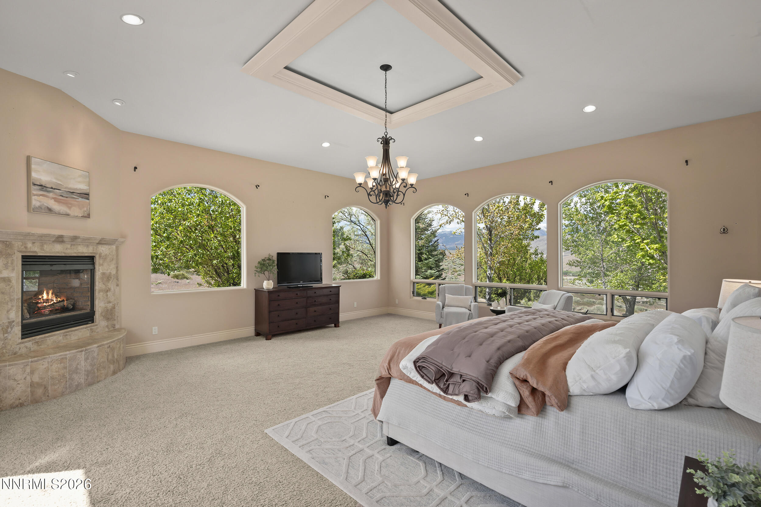 17300 Majestic View Drive Reno, NV 89521 - Photo 20 of 52 a spacious bedroom with a large bed and a chandelier