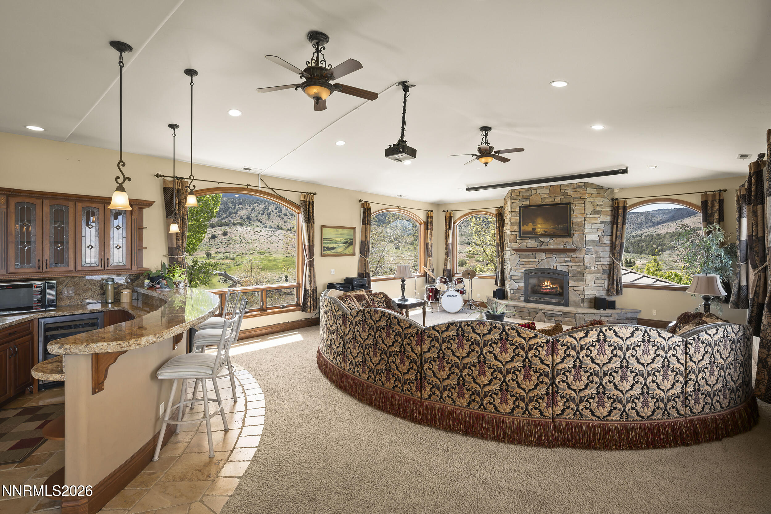 17300 Majestic View Drive Reno, NV 89521 - Photo 29 of 52 a living room with furniture a fireplace and a chandelier
