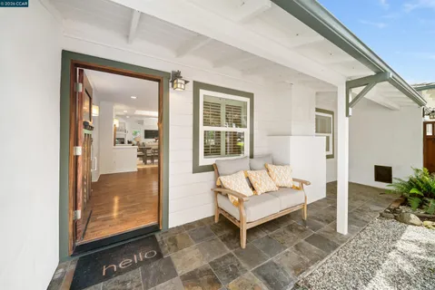 a dining room with furniture and a window
