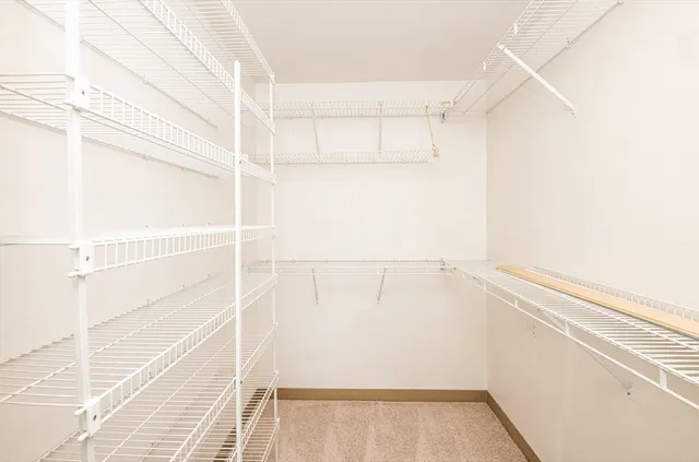 a bathroom with a granite countertop toilet a sink and a shower