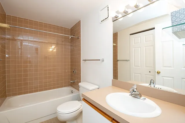 a kitchen with cabinets appliances a sink and a refrigerator