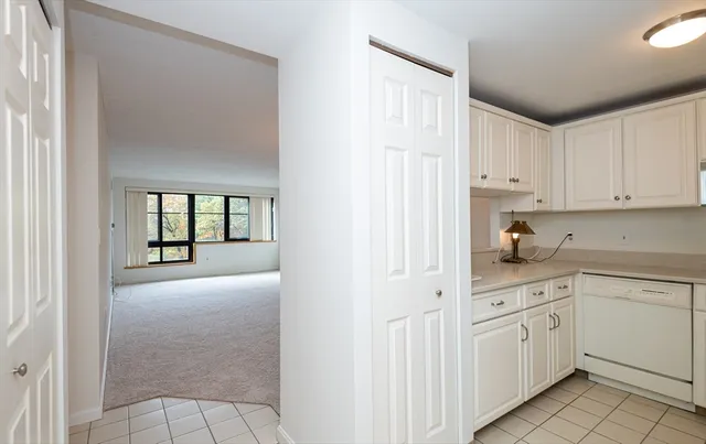 a kitchen with white cabinets and white appliances