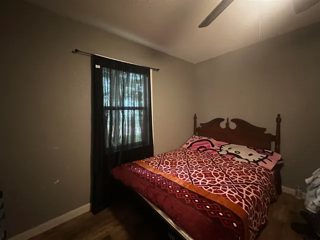 a bedroom with a bed and a window