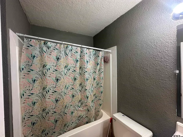 a bathroom with a bathtub and shower