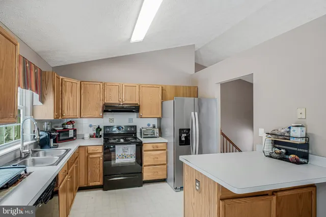 a kitchen with refrigerator a stove a sink dishwasher and a refrigerator