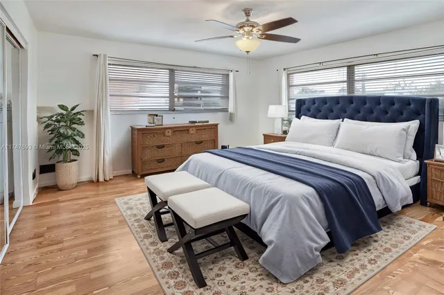 a spacious bedroom with a bed and a chandelier