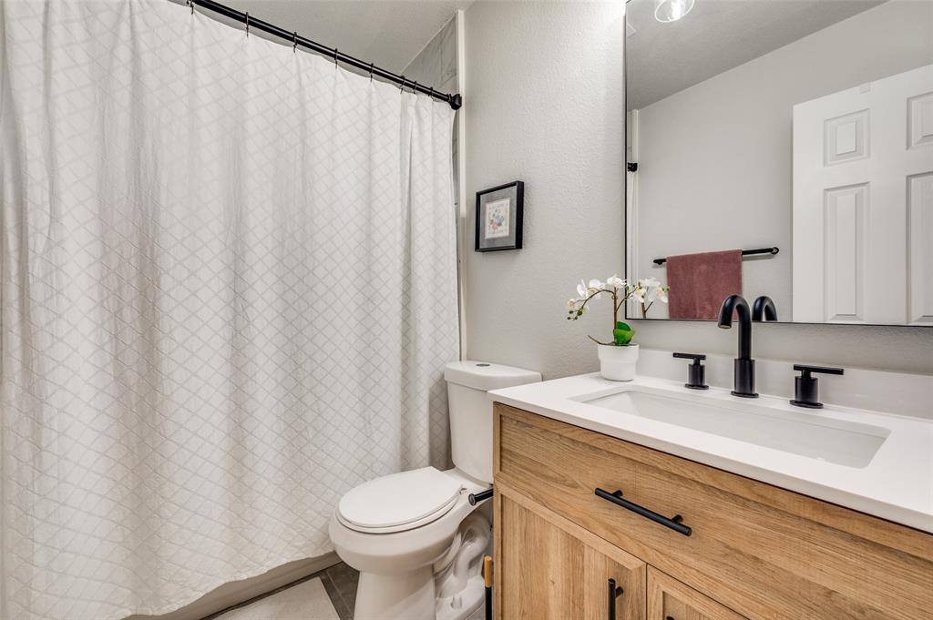7306 Vista Ridge Lane Sachse, TX 75048 - Photo 18 of 23 a bathroom with a sink toilet and mirror