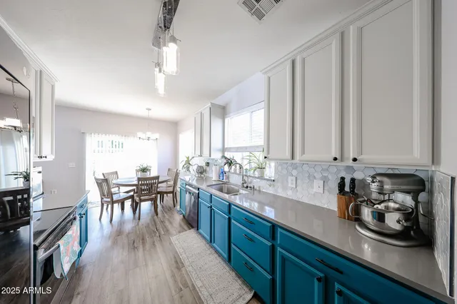a kitchen with stainless steel appliances granite countertop a refrigerator stove and sink