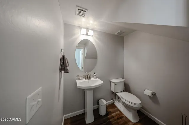 a bathroom with a sink toilet and a mirror
