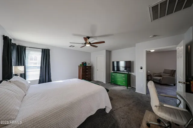 a bedroom with a bed and a mirror