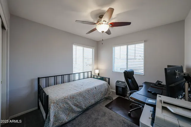 a bedroom with a bed and a chair