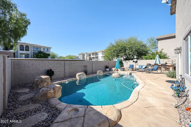 a view of a house with backyard and sitting area
