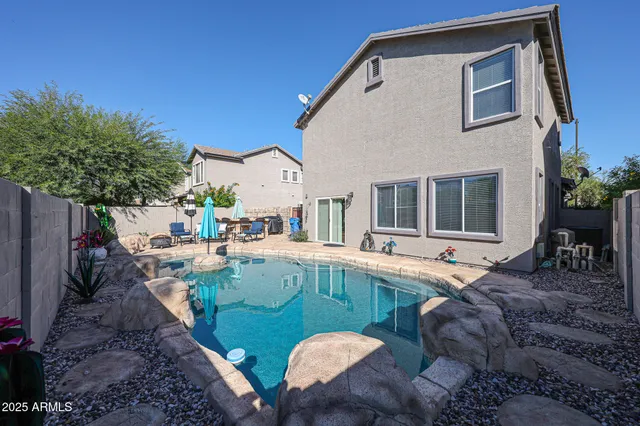 a view of backyard with outdoor seating and plants