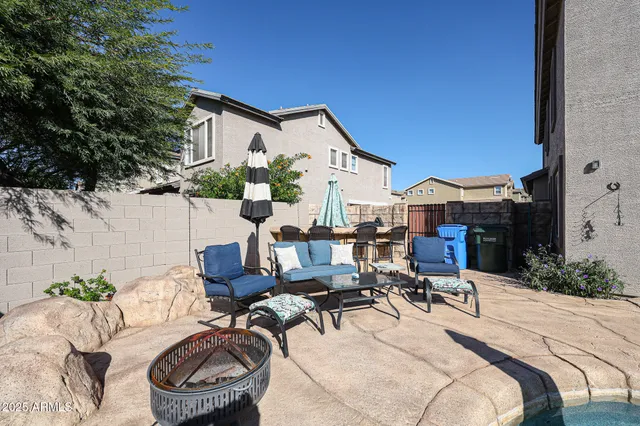 a view of backyard with barbeque grill and outdoor seating
