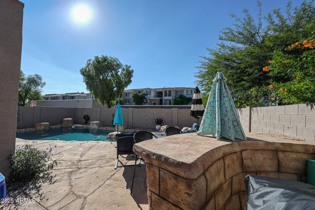 a view of a patio with table and chairs with wooden floor and fence