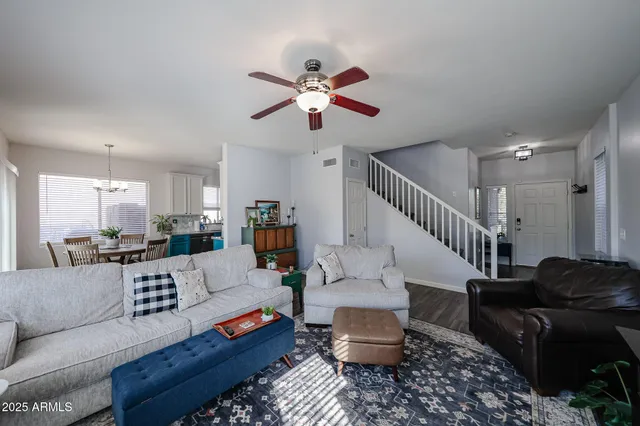 a living room with furniture and a wooden floor