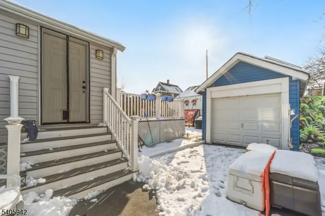 a view of a house with a small yard and furniture