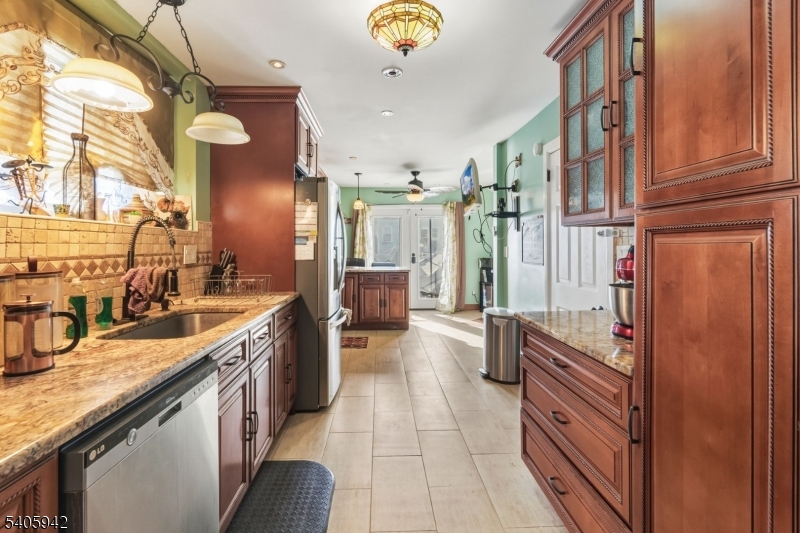 414 Martin Street Roselle, NJ 07203 - Photo 5 of 11 a kitchen with stainless steel appliances granite countertop a refrigerator and a stove