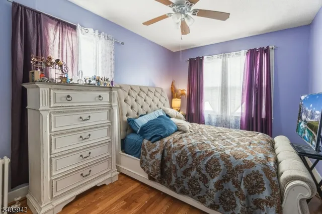 a bedroom with a large bed and a chandelier