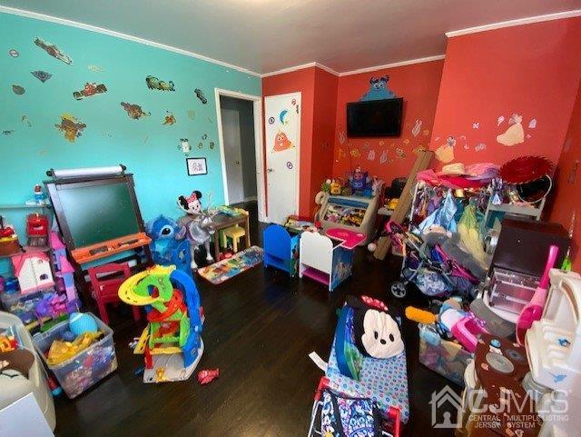 62 Tunison Road New Brunswick, NJ 08901 - Photo 11 of 23 a living room filled with furniture and a flat screen tv