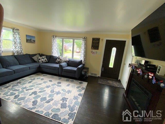 62 Tunison Road New Brunswick, NJ 08901 - Photo 3 of 23 a living room with furniture and a flat screen tv