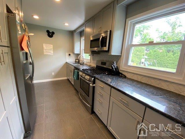 62 Tunison Road New Brunswick, NJ 08901 - Photo 6 of 23 a kitchen with stainless steel appliances granite countertop a refrigerator a stove a sink a washer dryer and a window