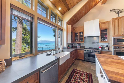 a kitchen with stainless steel appliances a sink stove and cabinets