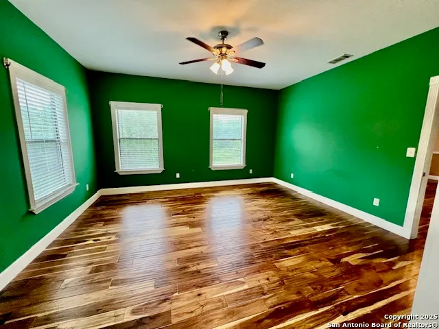 a view of room with window and ceiling fan