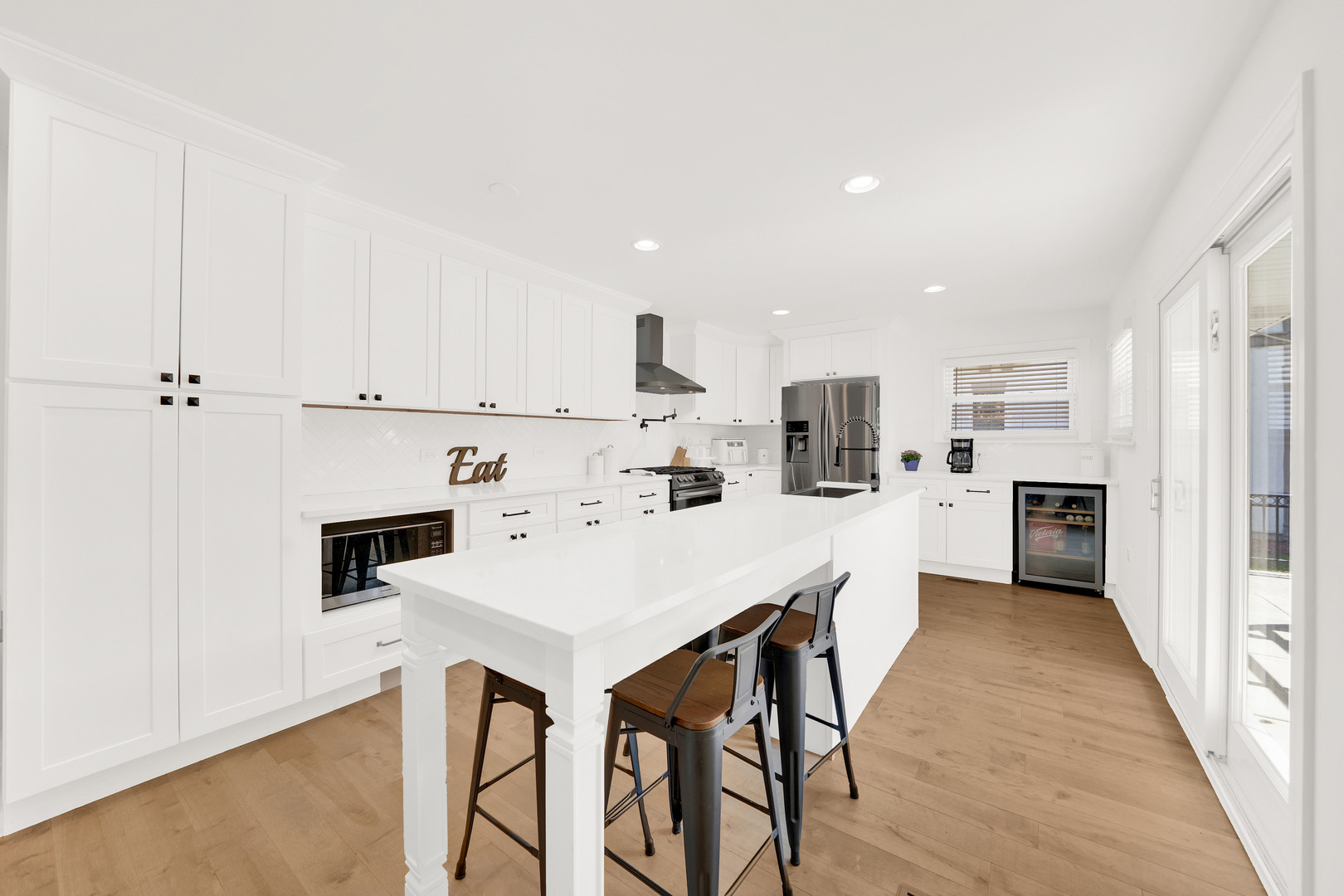 9737 West 57th Street Countryside, IL 60525 - Photo 5 of 19 a kitchen with white cabinets and stainless steel appliances