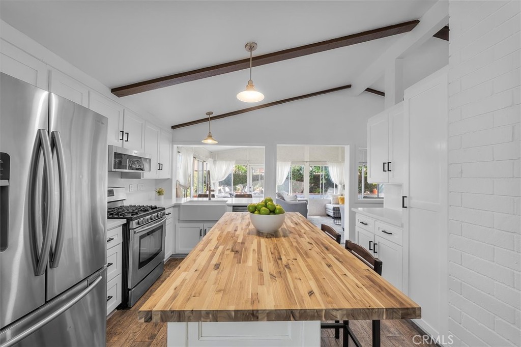 1702 East Dimondale Drive Carson, CA 90746 - Photo 12 of 43 a large kitchen with kitchen island a large counter space stainless steel appliances and furniture
