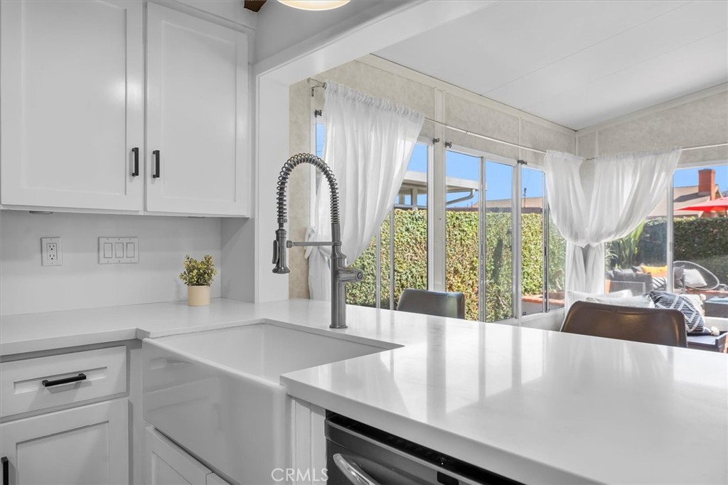 1702 East Dimondale Drive Carson, CA 90746 - Photo 19 of 43 a view of a kitchen with kitchen island a large window cabinets and stainless steel appliances