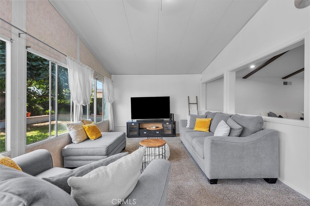 1702 East Dimondale Drive Carson, CA 90746 - Photo 22 of 43 a living room with furniture and a flat screen tv