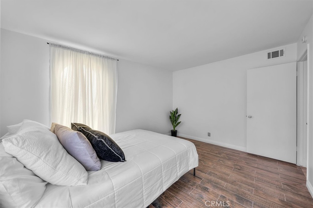 1702 East Dimondale Drive Carson, CA 90746 - Photo 28 of 43 a bed sitting in a bedroom next to a window