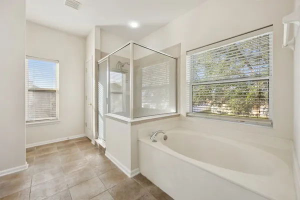 a bathroom with a bathtub and a shower