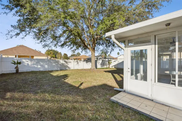 a view of a house with backyard and sitting area